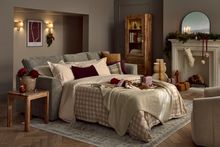 Luxurious bedding set with a decorative quilt and pillows on a neatly made chaise sofa bed.