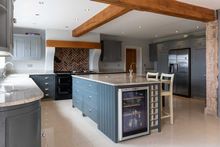 Modern kitchen featuring a sleek, grey centre island with built-in wine cooler.