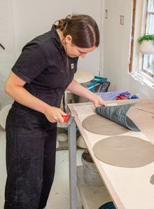 Katie Preece at her studio pressing Eala discs