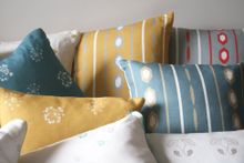 Kate Medlicott Cushions in Ikat Stripes and Tiny Trumpets Fabrics