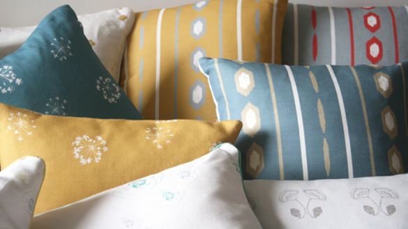 Kate Medlicott Cushions in Ikat Stripes and Tiny Trumpets Fabrics